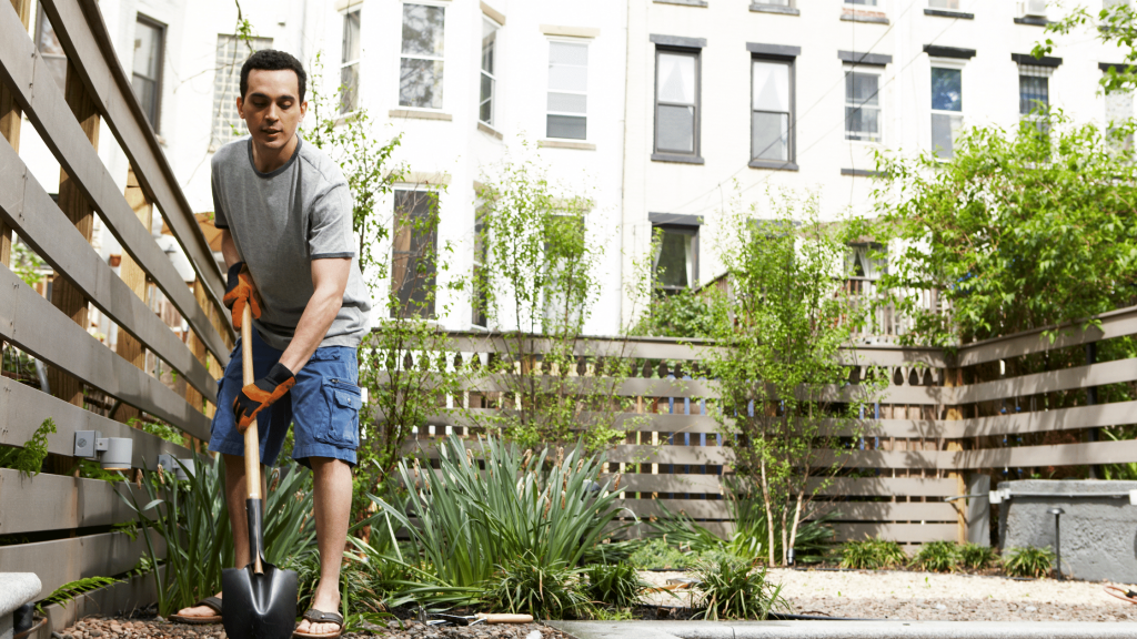 man gardening on an urban homestead